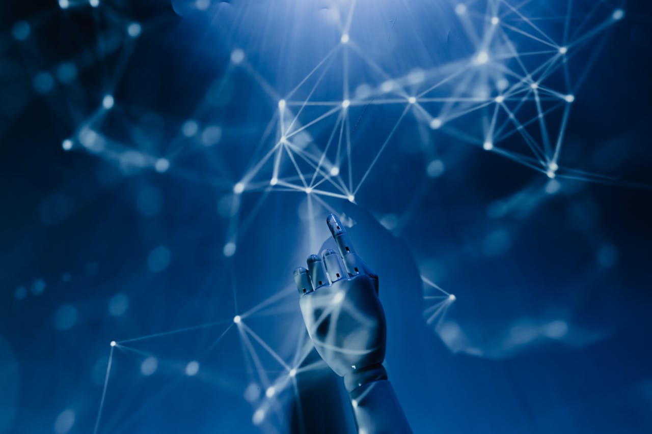 services-01 A robotic hand reaching into a digital network on a blue background, symbolizing AI technology.